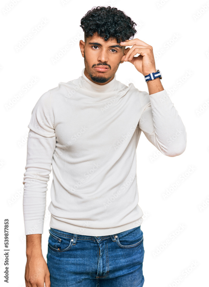 Fototapeta premium Young arab man wearing casual winter sweater worried and stressed about a problem with hand on forehead, nervous and anxious for crisis
