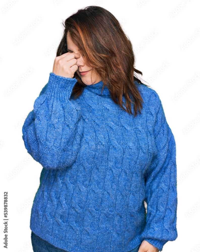 Young plus size woman wearing casual clothes tired rubbing nose and eyes feeling fatigue and headache. stress and frustration concept. Young plus size woman wearing casual clothes tired rubbing nose and eyes feeling fatigue and headache. stress and frustration concept.