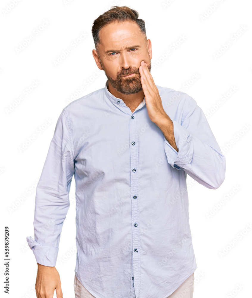 Handsome middle age man wearing business shirt touching mouth with hand with painful expression because of toothache or dental illness on teeth. dentist Handsome middle age man wearing business shirt touching mouth with hand with painful expression because of toothache or dental illness on teeth. dentist