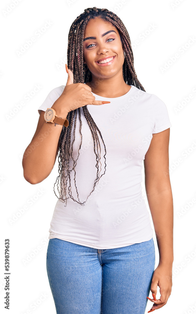 Young african american woman with braids wearing casual clothes smiling doing phone gesture with hand and fingers like talking on the telephone. communicating concepts. Young african american woman with braids wearing casual clothes smiling doing phone gesture with hand and fingers like talking on the telephone. communicating concepts.