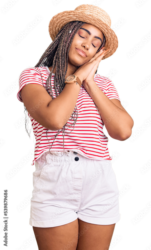 Young african american woman with braids wearing summer hat sleeping tired dreaming and posing with hands together while smiling with closed eyes. Young african american woman with braids wearing summer hat sleeping tired dreaming and posing with hands together while smiling with closed eyes.