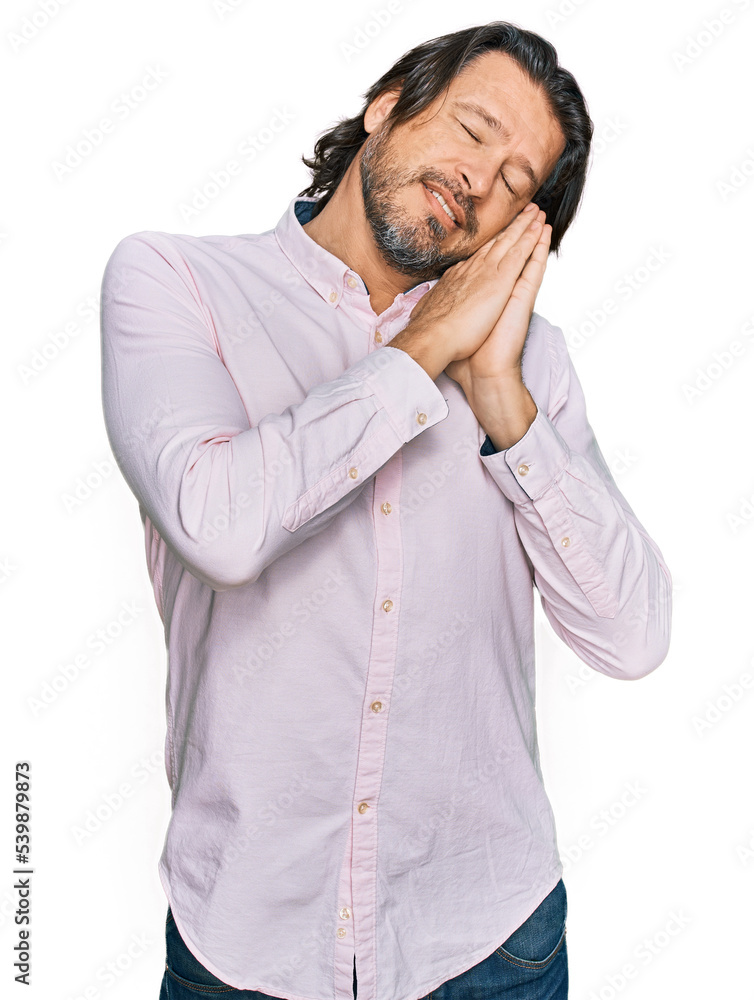 Middle age handsome man wearing business shirt sleeping tired dreaming and posing with hands together while smiling with closed eyes. Middle age handsome man wearing business shirt sleeping tired dreaming and posing with hands together while smiling with closed eyes.