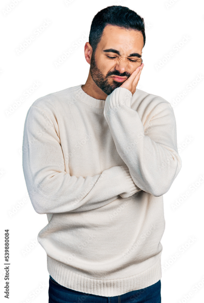 Young hispanic man with beard wearing casual white sweater thinking looking tired and bored with depression problems with crossed arms. Young hispanic man with beard wearing casual white sweater thinking looking tired and bored with depression problems with crossed arms.