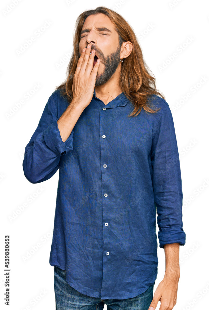 Attractive man with long hair and beard wearing casual clothes bored yawning tired covering mouth with hand. restless and sleepiness. Attractive man with long hair and beard wearing casual clothes bored yawning tired covering mouth with hand. restless and sleepiness.