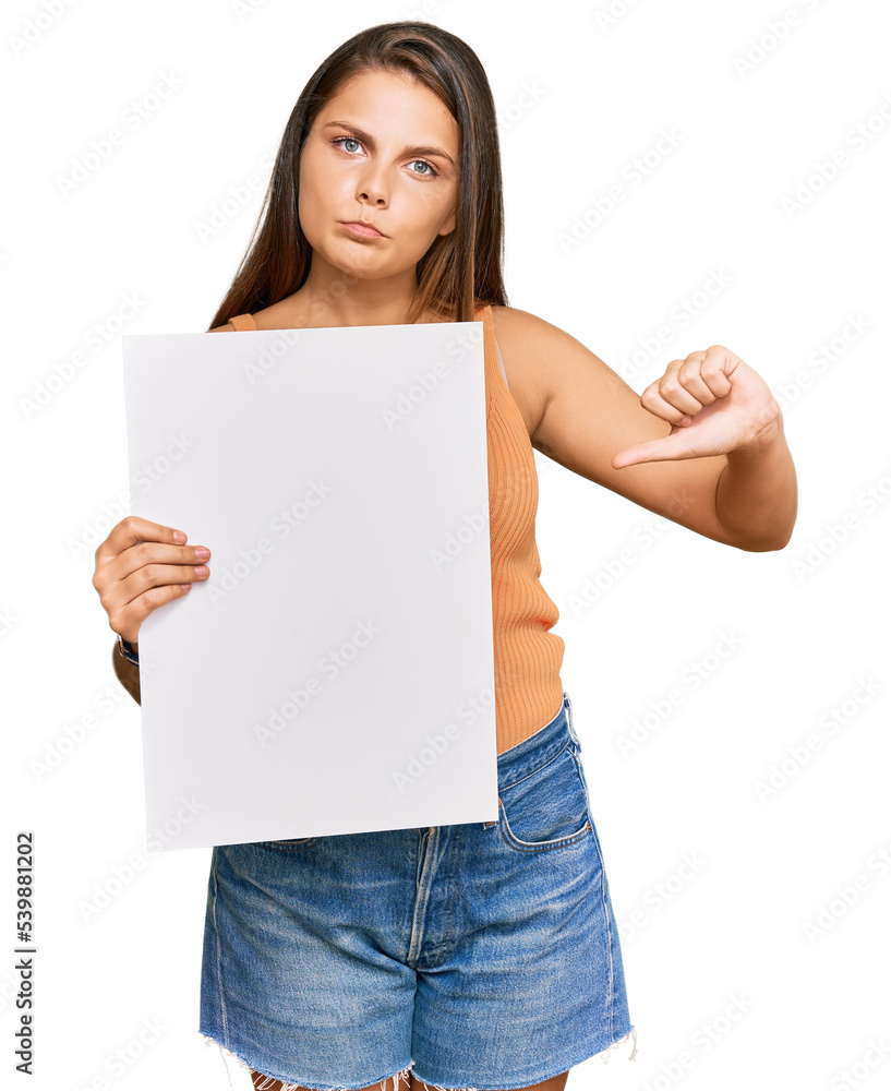 Young caucasian woman holding blank empty banner with angry face, negative sign showing dislike with thumbs down, rejection concept Young caucasian woman holding blank empty banner with angry face, negative sign showing dislike with thumbs down, rejection concept