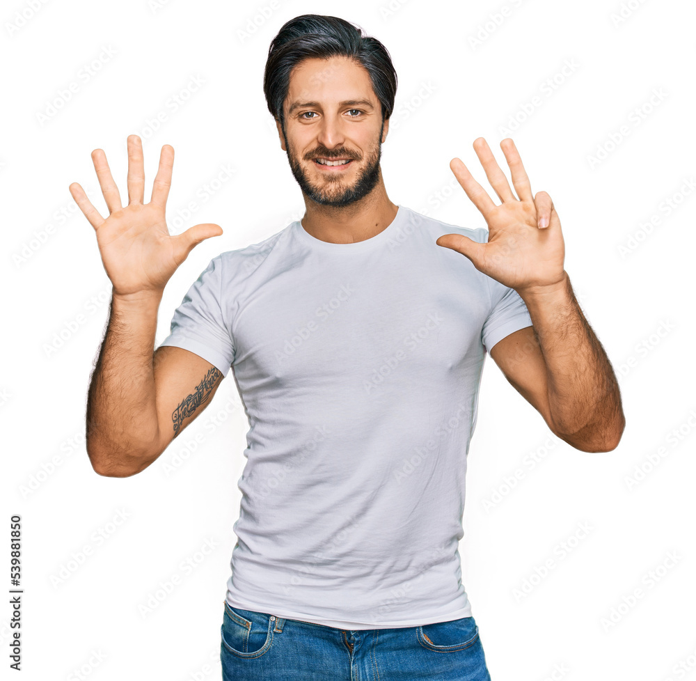 Young hispanic man wearing casual white t shirt showing and pointing up with fingers number nine while smiling confident and happy. Young hispanic man wearing casual white t shirt showing and pointing up with fingers number nine while smiling confident and happy.