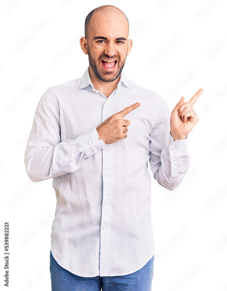 Young handsome man wearing elegant shirt smiling and looking at the camera pointing with two hands and fingers to the side. Young handsome man wearing elegant shirt smiling and looking at the camera pointing with two hands and fingers to the side.