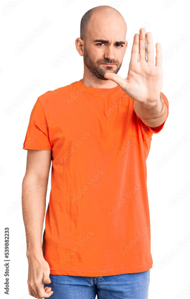Young handsome man wering casual t shirt doing stop sing with palm of the hand. warning expression with negative and serious gesture on the face. Young handsome man wering casual t shirt doing stop sing with palm of the hand. warning expression with negative and serious gesture on the face.