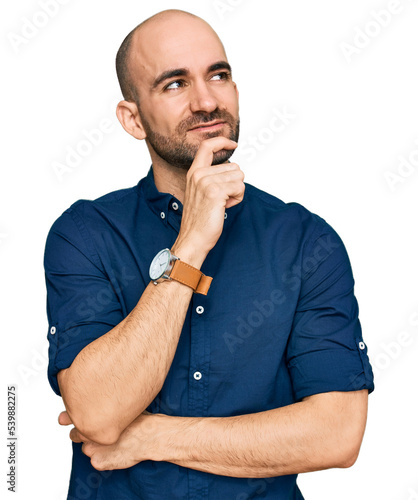 Young hispanic man wearing casual clothes with hand on chin thinking about question, pensive expression. smiling and thoughtful face. doubt concept.