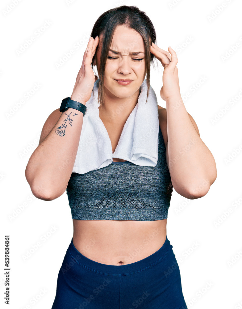 Young hispanic girl wearing sportswear and towel with hand on head, headache because stress. suffering migraine. Young hispanic girl wearing sportswear and towel with hand on head, headache because stress. suffering migraine.