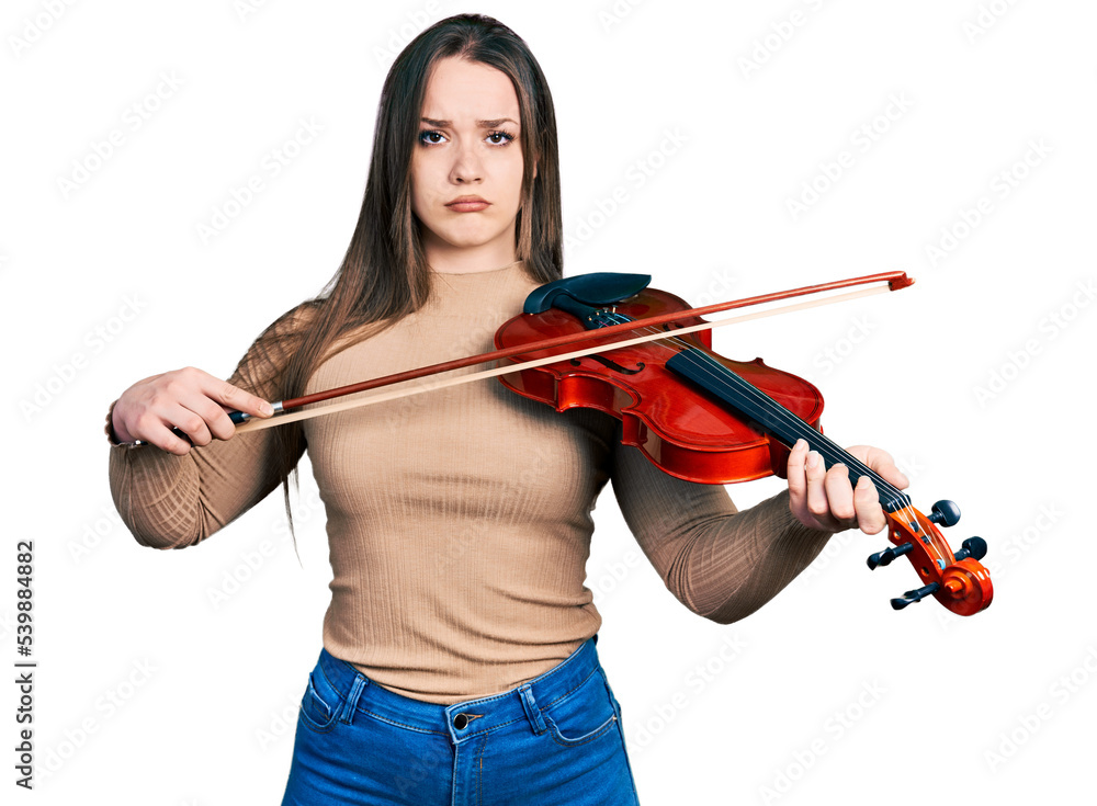 Young hispanic girl playing violin depressed and worry for distress, crying angry and afraid. sad expression. Young hispanic girl playing violin depressed and worry for distress, crying angry and afraid. sad expression.