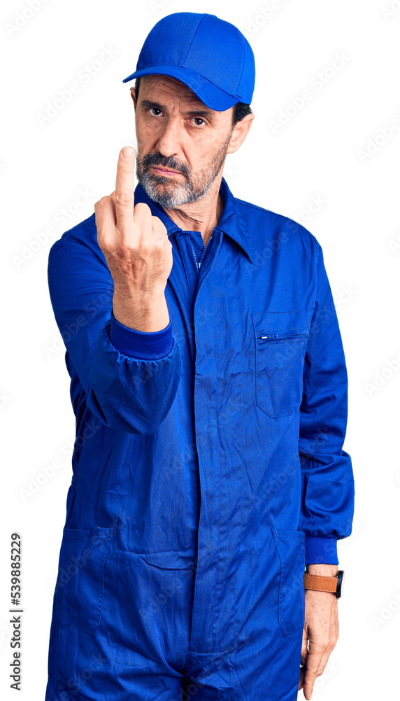 Middle age handsome man wearing mechanic uniform showing middle finger, impolite and rude fuck off expression Middle age handsome man wearing mechanic uniform showing middle finger, impolite and rude fuck off expression