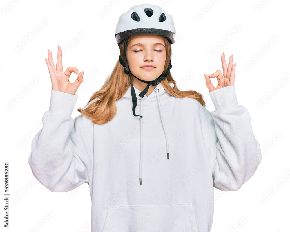 Beautiful young caucasian girl wearing bike helmet relax and smiling with eyes closed doing meditation gesture with fingers. yoga concept. Beautiful young caucasian girl wearing bike helmet relax and smiling with eyes closed doing meditation gesture with fingers. yoga concept.
