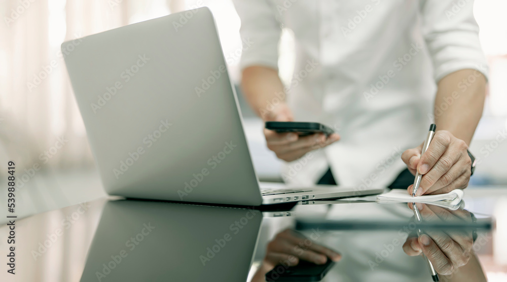 Fototapeta premium Businessman hand writing note and using digital tablet in office, Online marketing and Big data technology for E-commerce business.