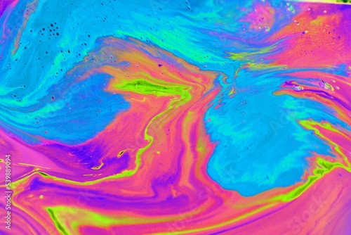 Abstract multicolored marble background. Acrylic paint spreads freely and creates an interesting pattern. Background for the cover of a laptop, notebook.