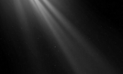 Show spotlights with glow effect on dark background.