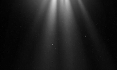 Show spotlights with glow effect on dark background.