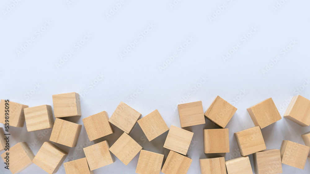 Fototapeta premium Top view of wooden cube on a white background with copy space.