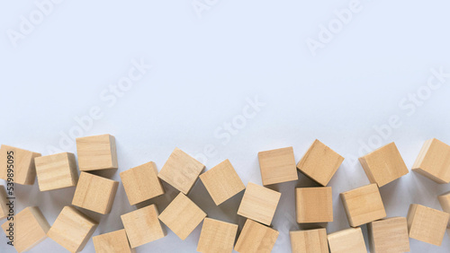 Top view of wooden cube on a white background with copy space.