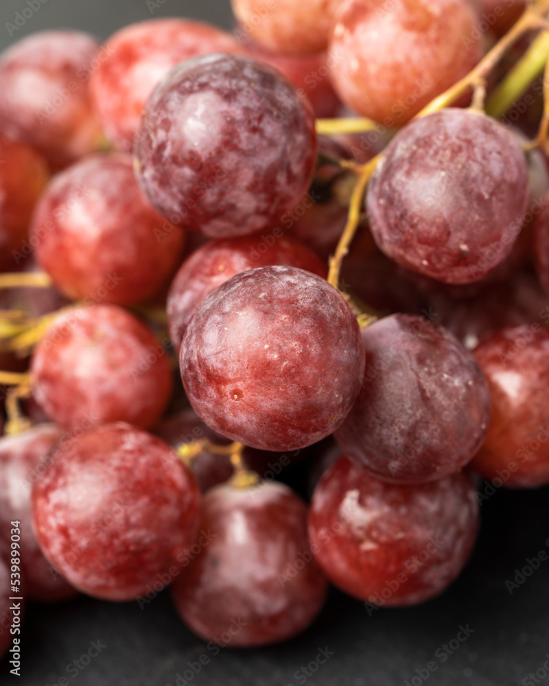 Harvest of ripe, juicy, red grapes with large berries close-up Harvest of ripe, juicy, red grapes with large berries close-up