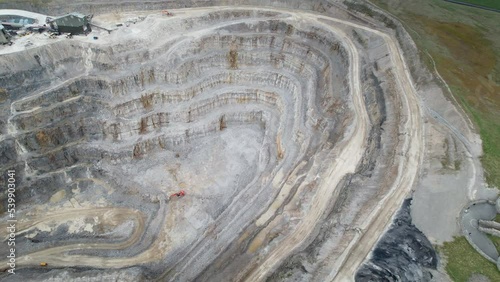 Aerial drone pan shot over green grasslands surrounding Hanson Aggregates Quarry in Harrogate, North Yorkshire, England, UK at daytime. photo