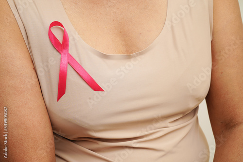 Asian woman with pink ribbon, World Breast Cancer Day at October.