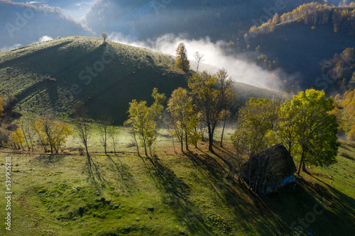 Aerial view of autumn countryside farm  with abandoned wooden houses and barns in the mountains