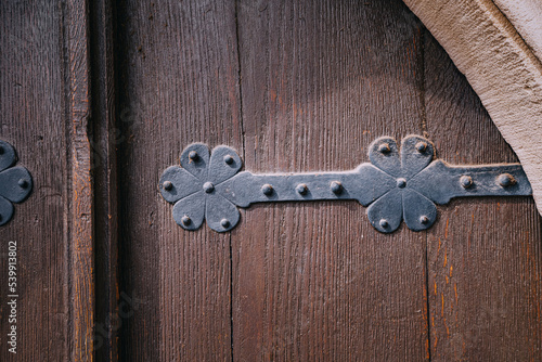 Iron old rivets of a wooden church or historical town hall door. Quest game and mystical background