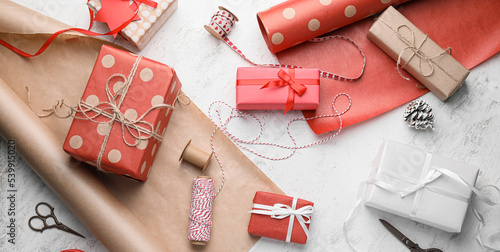 Beautiful gift boxes for Christmas and wrapping paper on light background, top view photo