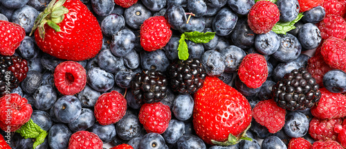 Fototapeta Naklejka Na Ścianę i Meble -  Different fresh berries as background, top view