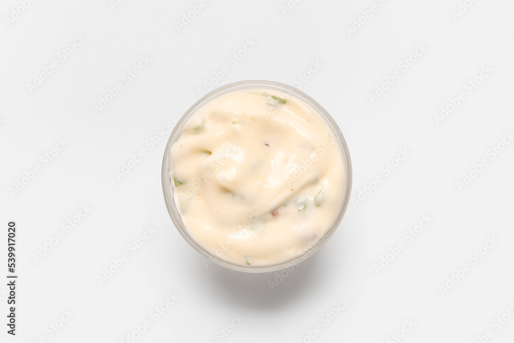 Glass bowl with tasty Caesar sauce on white background Glass bowl with tasty Caesar sauce on white background