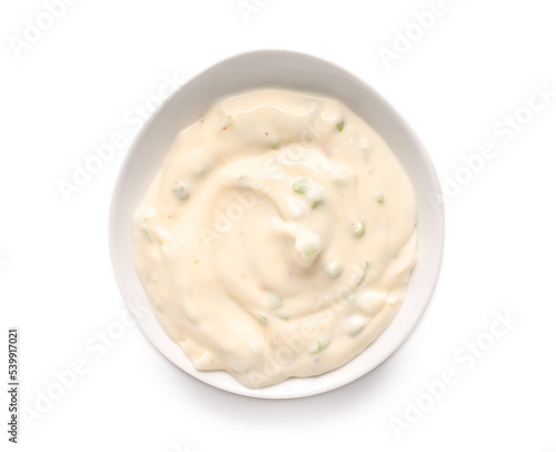 Sauce bowl with tasty Caesar salad dressing on white background