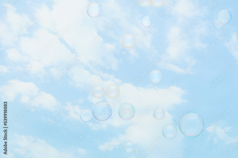 Soap bubbles on beautiful sky background