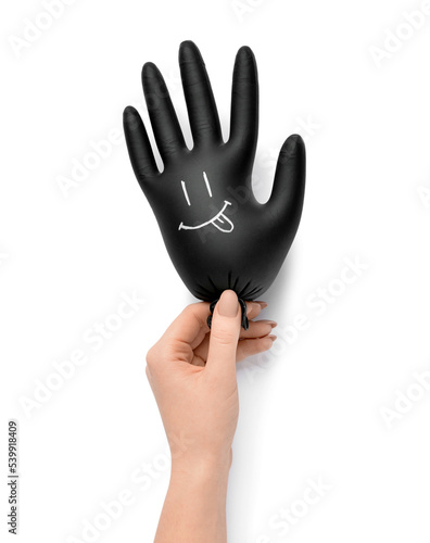 Woman holding medical glove...