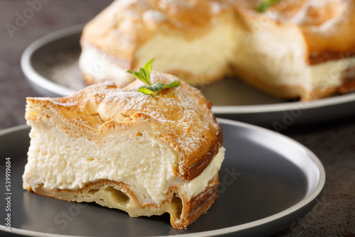 Fototapeta Naklejka Na Ścianę i Meble -  Polish Carpathian mountain cream cake that consists of two layers of choux pastry and delicious pastry cream in between closeup on the plate on the table. Horizontal