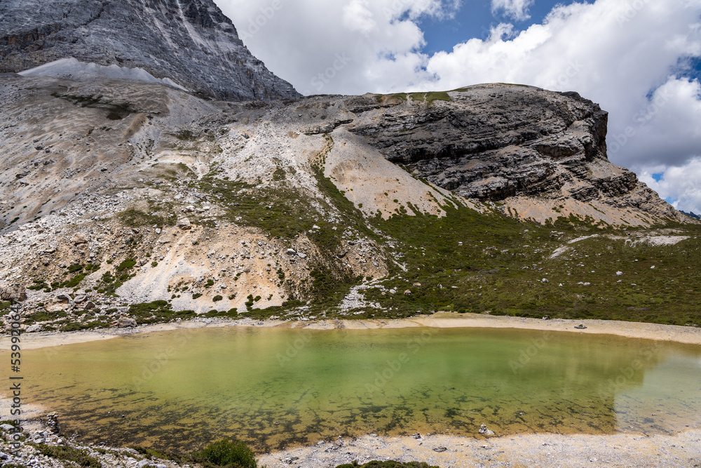 Fototapeta premium Emerald glacier lake in peak of snow mountains at Yading Nature Reserve, China. 4000 meters above the sea level, high altitude lake