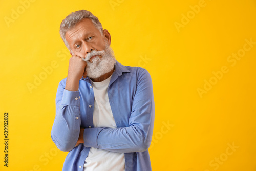 Thoughtful mature man on ye...