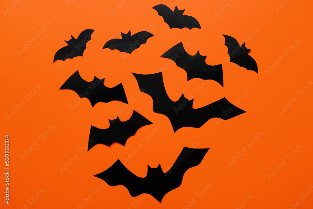 Paper bats for Halloween party on color background