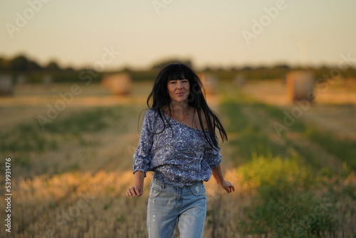 Raped and abused girl in emotional stress wanders around the field, her face expresses fatigue and doom, a victim of physical and psychological violence, an insulted and beaten person