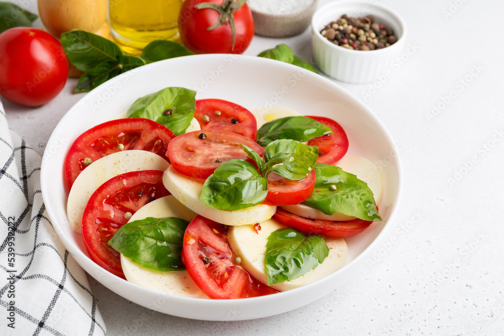 Caprese Salad with tomatoes and mozzarella with olive oil. Caprese Salad with tomatoes and mozzarella with olive oil.