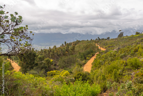 Fototapeta Naklejka Na Ścianę i Meble -  Panorama of the landscape in the Paarl Rock Nature Reserve with clouds and small footpath visible
