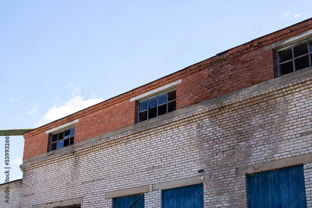 Old factory building with broken glass closeup