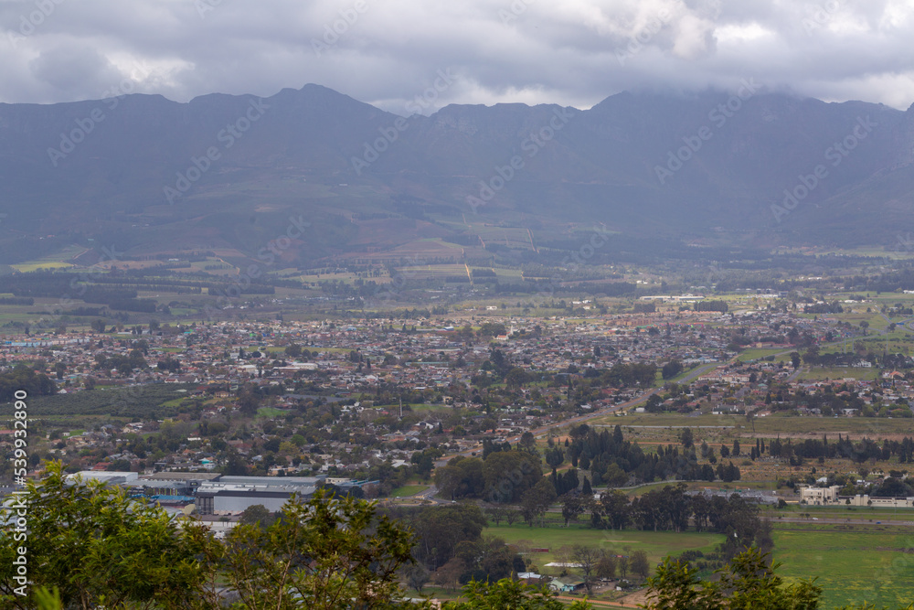 View down to the town of Paarl on a cloudy day taken from Paarl Rock