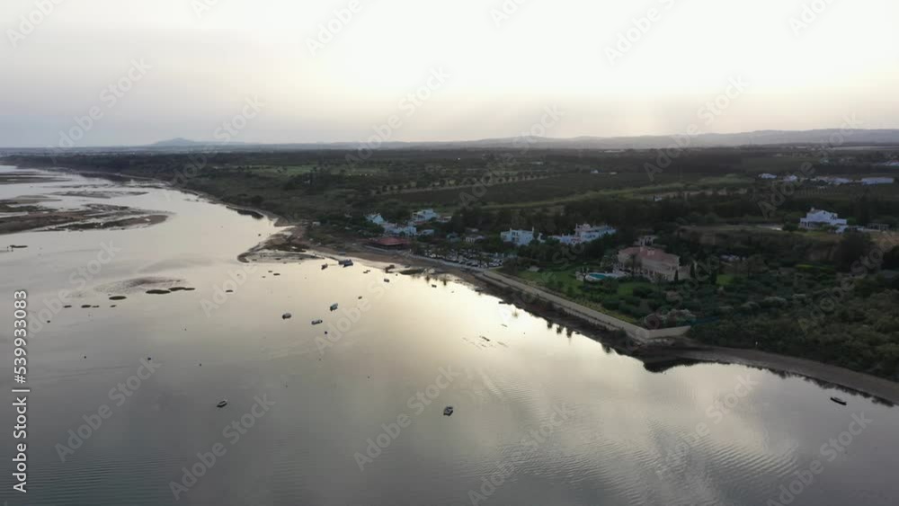 Aerial View Of Ria Formosa Lagoon At Low Tide With Holiday Home and Resort In Praia da Fabrica, Vila Nova de Cacela, Portugal. Aerial View Of Ria Formosa Lagoon At Low Tide With Holiday Home and Resort In Praia da Fabrica, Vila Nova de Cacela, Portugal.