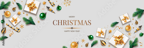 Horizontal banner with gold Christmas symbols and text. Christmas tree, gift, golden tinsel confetti and snowflakes on light background. Header for website template.

