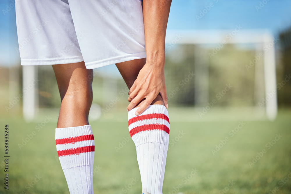 Sports, soccer player and man with knee injury, torn muscle or strain after game, competition or fitness practice. Exercise, grass pitch workout or football training accident for athlete legs in pain