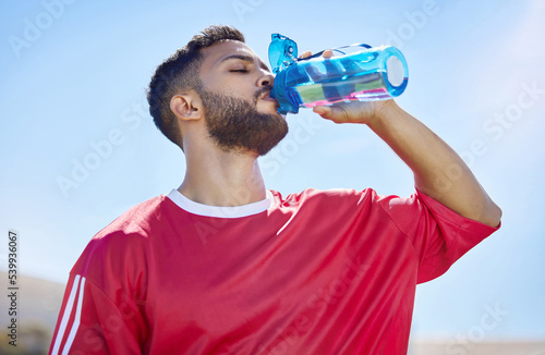 Sports, fitness and drinking water with man in sunshine and blue sky mock up for outdoor wellness, training and healthy lifestyle. Tired athlete with water bottle for workout, exercise or practice