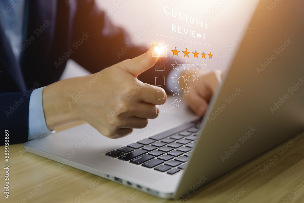 Positive customer reviews, businessman's hand marks a five-star rating Positive customer reviews, businessman's hand marks a five-star rating