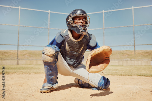 Baseball, sports and man waiting on a field during a game, competition or training. Athlete catcher playing a sport with focus for exercise and fitness in nature or a park at an event in summer