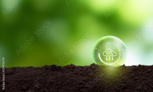 Reduction of carbon emissions, carbon neutral concept. Net zero greenhouse gas emissions target..Reducing carbon footprint concept. Decreasing CO2 emissions target symbol on green view background.